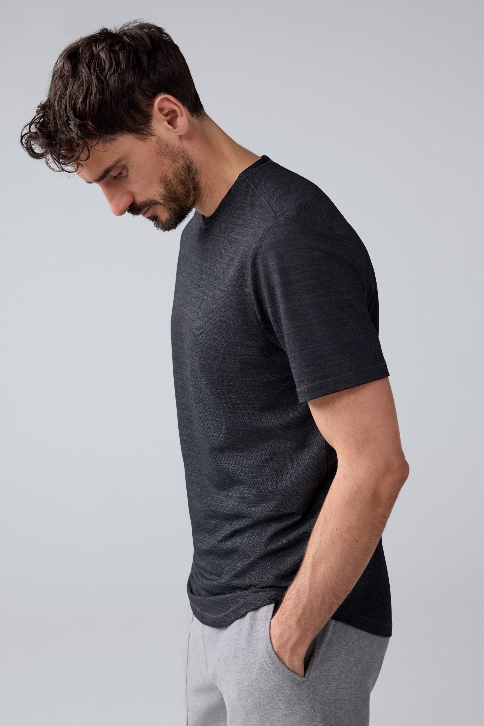 Side view of a man wearing AIRKNITx Crew Neck T-Shirt in Anthracite