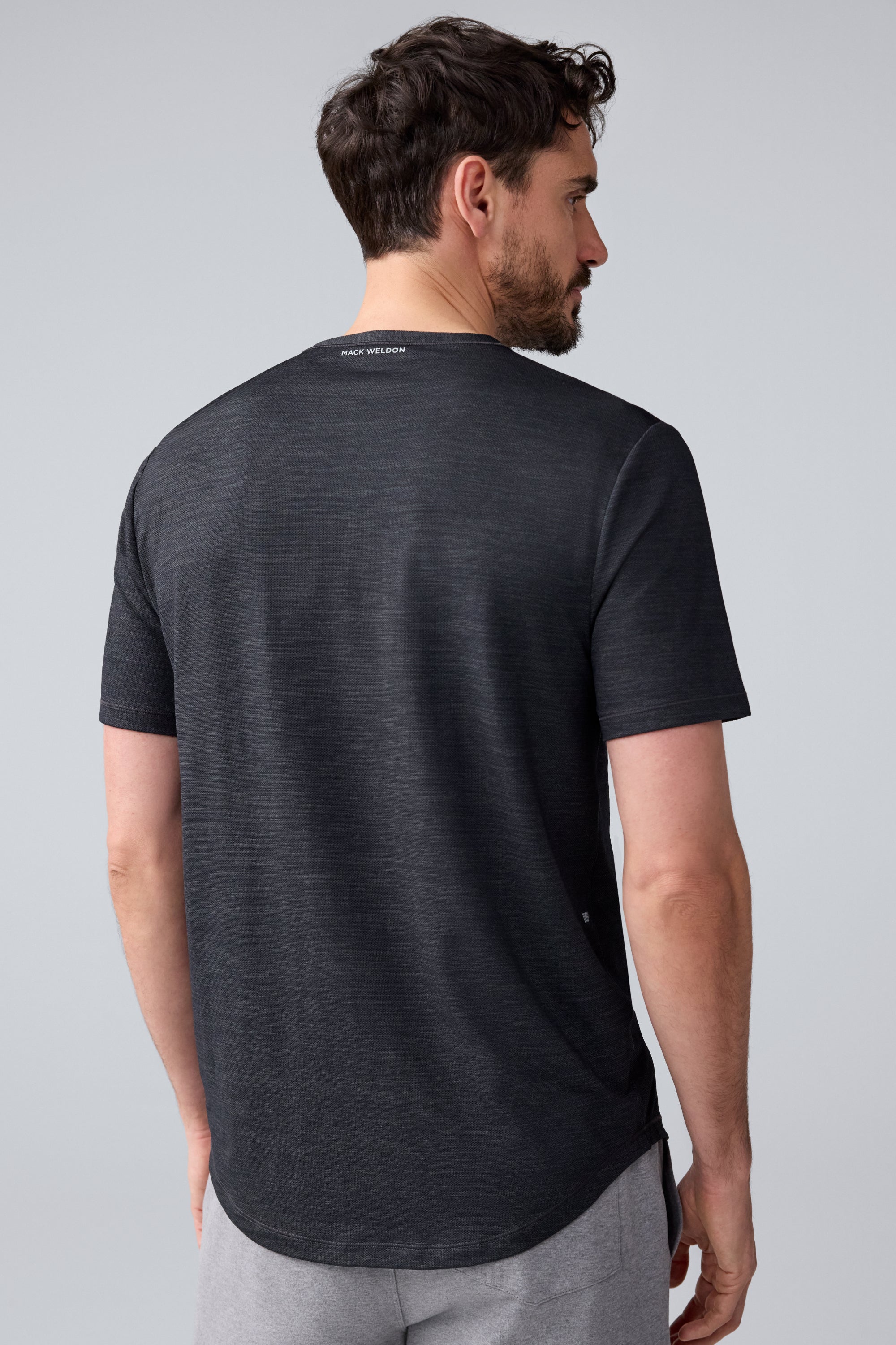 Back view of a man wearing AIRKNITx Crew Neck T-Shirt in Anthracite